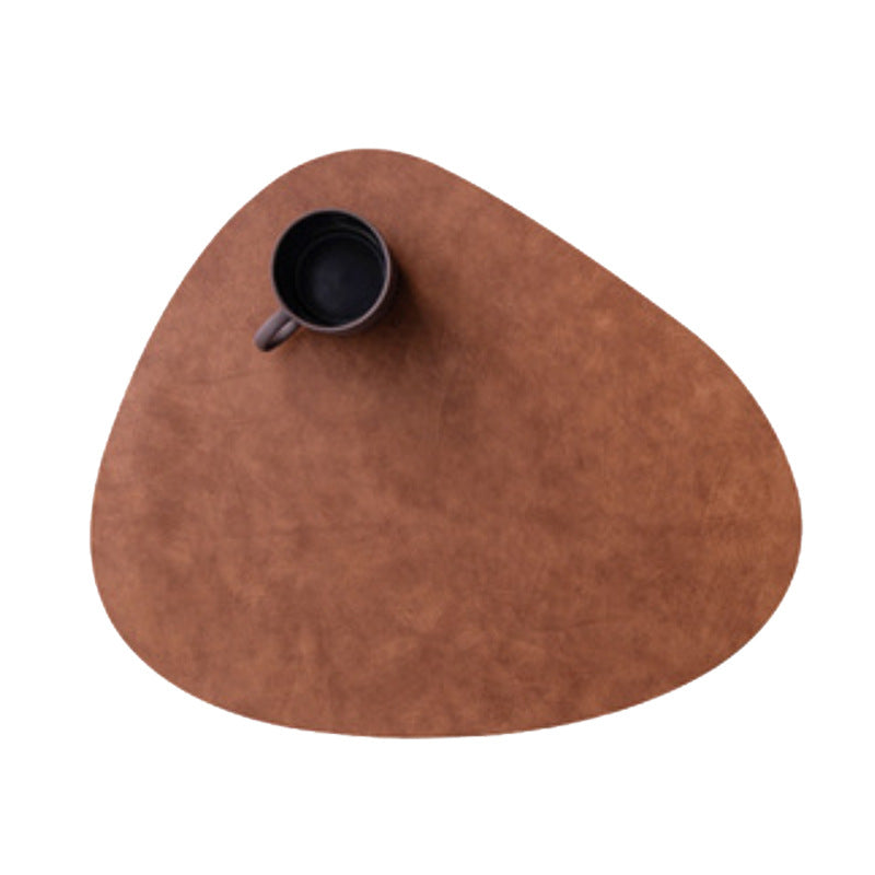 Tuscany leather placemat set in Mud Gray styled on a modern dining table