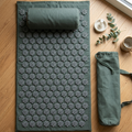 Acupressure mat pillow set and carry bag flat lay — self-care wellness gift
