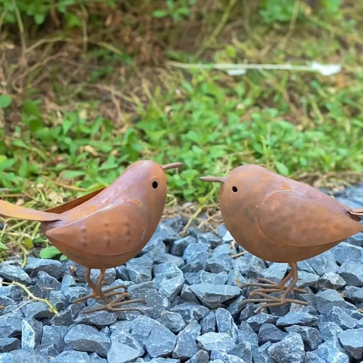 Flat lay of the rustic iron bird garden decoration on natural linen fabric
